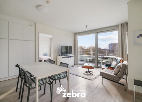 Moderne serviceflat met prachtig zicht op de Leie en autostaanplaats te Deinze!